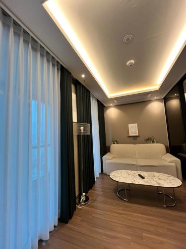 a living room with a couch and a table at Haeundae Lamer Stay in Busan