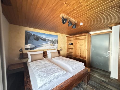 a bed in a room with a wooden ceiling at Black Forest Hotel Todtnau in Todtnau