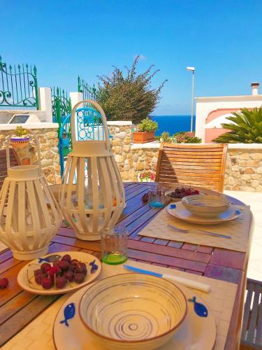 a wooden table with plates of food on it at PonzaSmeralda Le Forna in Ponza
