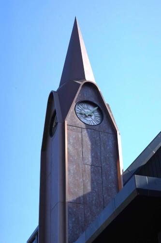 a tall clock tower with a clock on it at Viewpoint Khaoyai Hotel in Mu Si