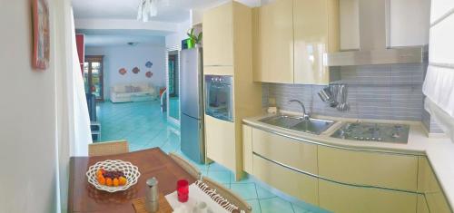 a kitchen with a sink and a table in it at PonzaSmeralda Le Forna in Ponza