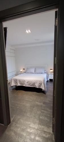 a bedroom with a bed in a white room at Hotel Aldori Landetxea - Reserva de la Biosfera Urdaibai - Adults Only in Muxika
