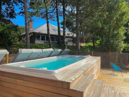 une grande piscine avec une terrasse et des chaises autour dans l'établissement Élégant mobil-home, à Le Touquet Airport