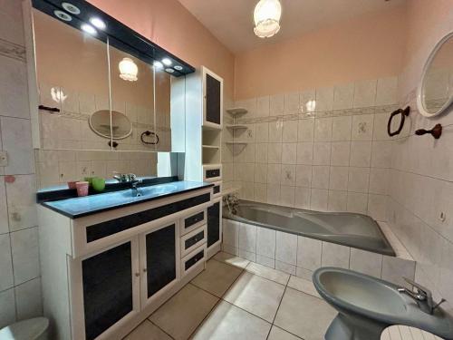 une salle de bain avec une baignoire et un lavabo et une baignoire dans l'établissement Maison 4 pièces 6 couchages ST CYPRIEN PLAGE SC00-30EL, à Saint Cyprien Plage