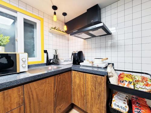 a kitchen with a sink and a microwave at Residence YeoYu Uijeongbu Station in Uijeongbu