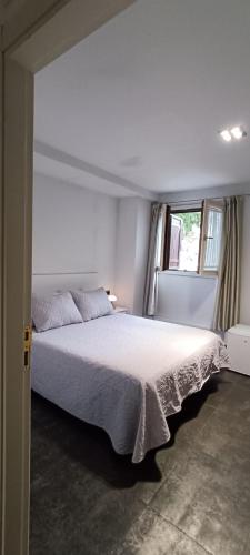 a bedroom with a large white bed with a window at Hotel Aldori Landetxea - Reserva de la Biosfera Urdaibai - Adults Only in Muxika