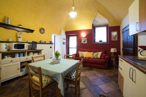 アローナにあるCasa Corte Alla Roccaのキッチン、リビングルーム(テーブル、ソファ付)