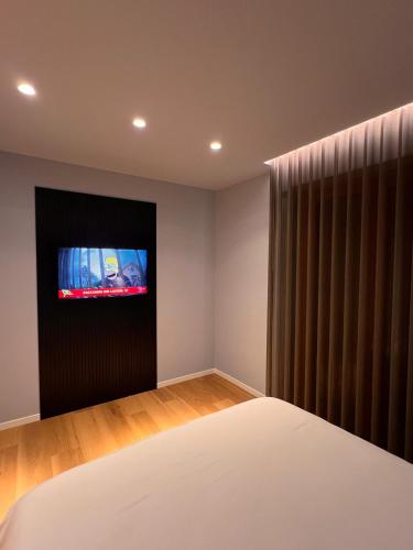 a bedroom with a bed and a tv on the wall at In Cavour 127 in Andria