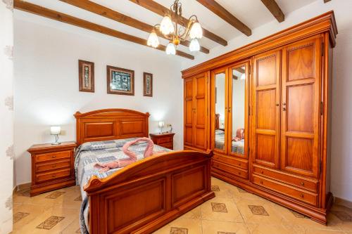 a bedroom with a wooden bed and wooden cabinets at La Tierra in Níjar