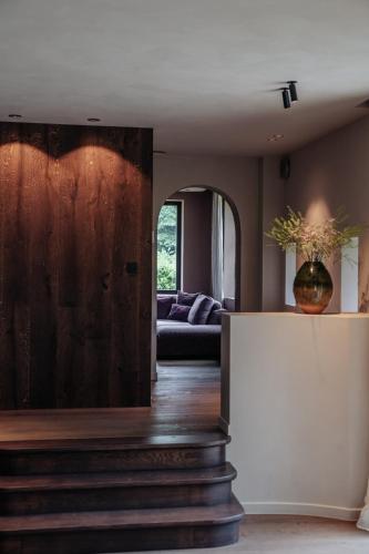 a living room with a couch and a table at Le Temps de Vivre Chimay - Ardennen in Momignies