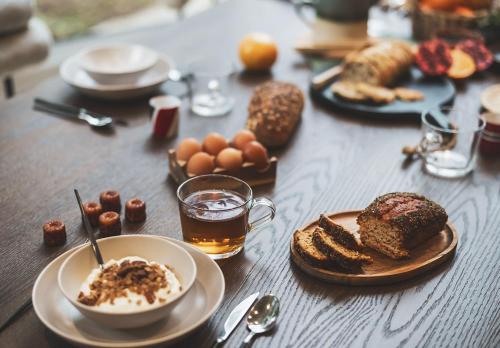 a table topped with plates of food and drinks at Parc Victoria Appartements in Saint-Jean-de-Luz