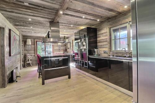 a kitchen with wooden floors and a counter top at Les Pives in Icogne