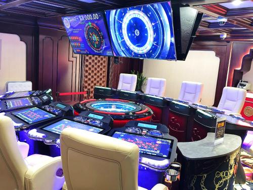 a room with a bunch of poker tables and chairs at Hanoi Hotel in Hanoi