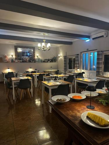 a dining room with tables and chairs in a restaurant at Hotel Boavista - Vintage House in Monfortinho