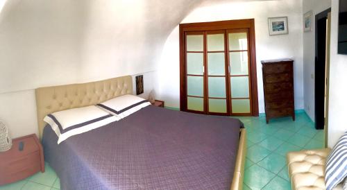 a bedroom with a large bed and a window at PonzaSmeralda Le Forna in Ponza