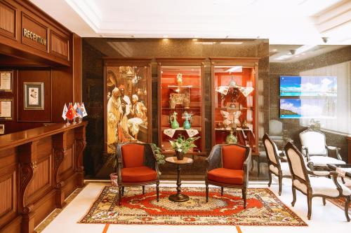 a lobby with chairs and a table in a store at Armida City Hotel in Canakkale