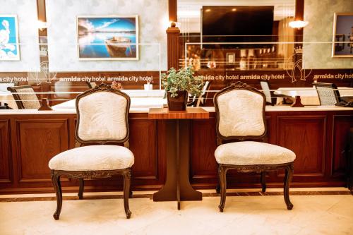two chairs sitting at a counter in a bar at Armida City Hotel in Canakkale