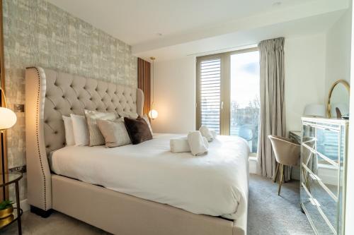 a bedroom with a large white bed and a window at Four Zero Six @ Ryedale House in York