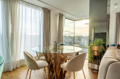 a dining room with a glass table and chairs at Four Zero Six @ Ryedale House in York