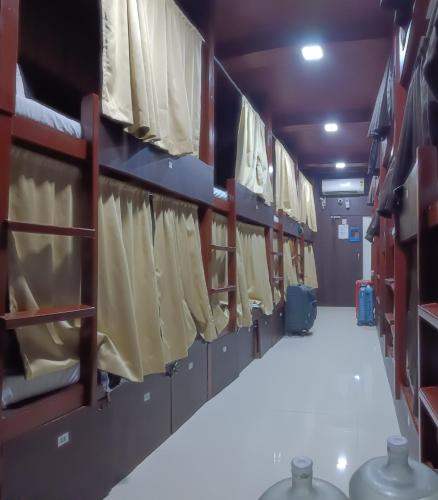 a locker room with a row of shirts on racks at ASRA DORMITORY For Male And Female in Mumbai
