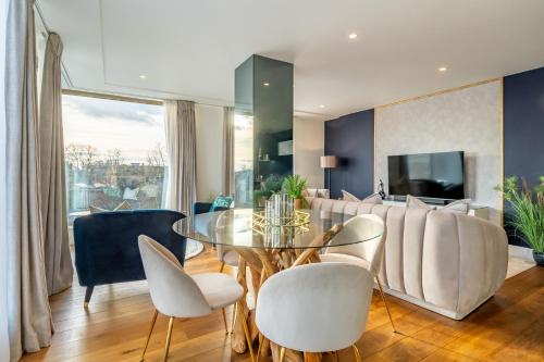 a dining room with a glass table and white chairs at Four Zero Six @ Ryedale House in York