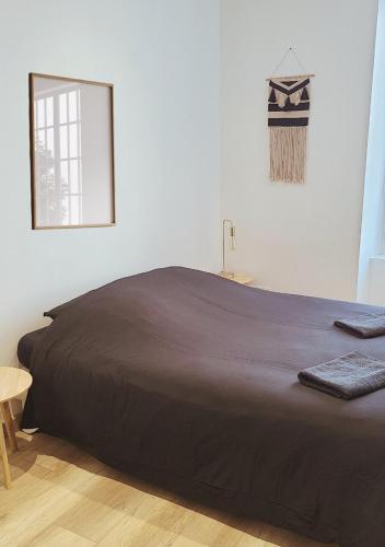 a large bed in a room with a mirror at L'Oasis de Fougères in Fougères