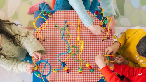 a group of children playing with toys on a table at AX ODYCY Hotel in St Paul's Bay