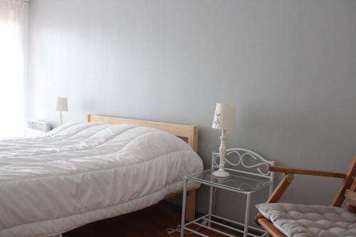 une chambre avec un lit et une table avec une lampe dans l'établissement Appt 2 pièces LA ROCHELLE - LR660-116, à La Rochelle
