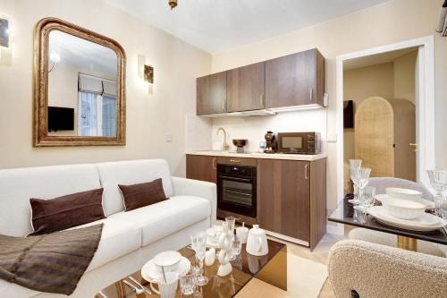 un salon avec un canapé blanc et une table dans l'établissement Charming apartment with AC a proximite de Republique, à Paris