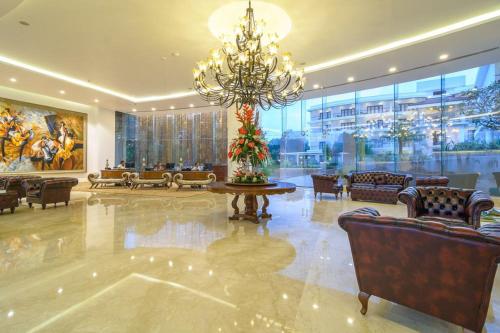 a large lobby with a chandelier and chairs and a table at Park Regis Goa in Arpora