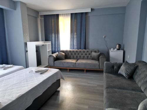 a living room with a couch and a couch and a living room at Akman City Hotel in Kusadası