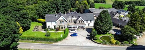 an aerial view of a large house with a driveway at Newton House Hotel in Alstonfield