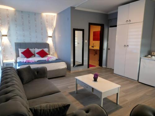 a living room with a couch and a bed at Akman City Hotel in Kusadası