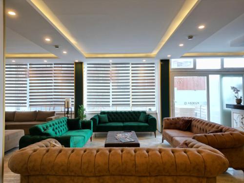 a large living room with couches and a table at Akman City Hotel in Kusadası