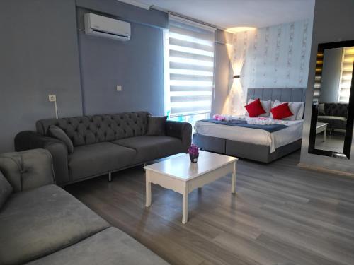 a living room with a couch and a bed at Akman City Hotel in Kusadası