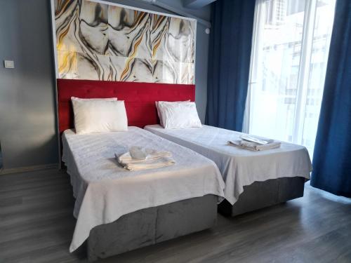 a bedroom with two beds with towels on them at Akman City Hotel in Kusadası