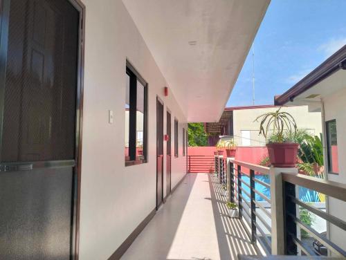 an empty corridor of a building with a balcony at JMorino Pension House in Puerto Princesa City