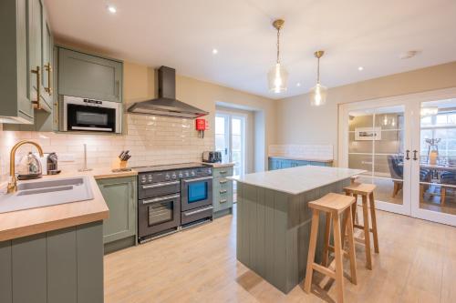 a kitchen with green cabinets and a counter top at Cofford Farm in Exeter