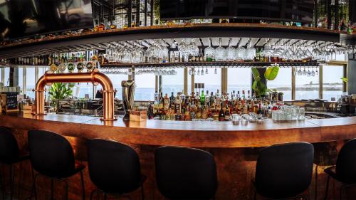 a bar with a view of the ocean at AX ODYCY Hotel in St Paul's Bay