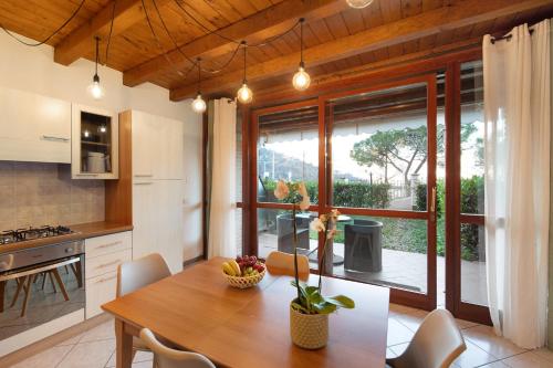 a kitchen with a wooden table and a dining room at Lake and Love - Lago D'Iseo in Sulzano
