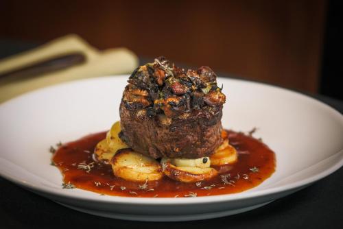 a piece of meat on a plate with sauce at Stallingborough Grange Hotel in Stallingborough