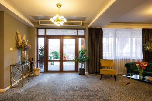 a living room with a couch and a glass door at Aria by Brilliant in Zalău