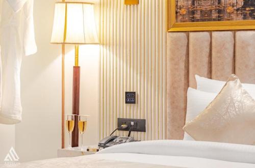 a bedroom with a bed with a lamp and a phone at Arison Luxury in Srinagar