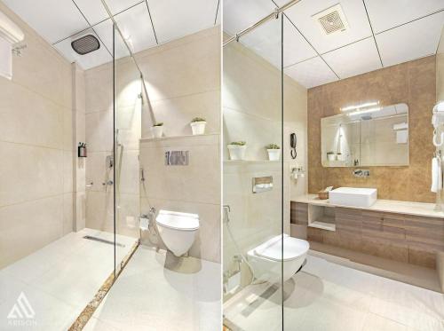 a bathroom with a shower and a toilet and a sink at Arison Luxury in Srinagar