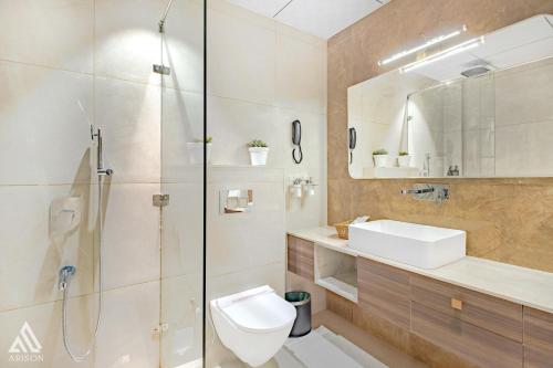 a bathroom with a shower and a toilet and a sink at Arison Luxury in Srinagar