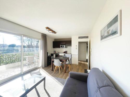 un salon avec un canapé et une table dans l'établissement Studio 314 - LES SUITES DE ROBINSON - Résidence avec piscine en bord de Siagne, à Mandelieu-La-Napoule, à Mandelieu-la-Napoule