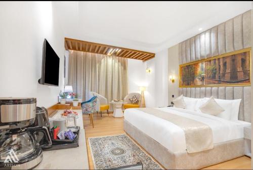 a bedroom with a large white bed and a living room at Arison Luxury in Srinagar