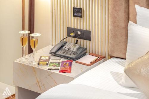 a desk with a phone on top of a bed at Arison Luxury in Srinagar