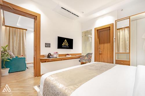 a bedroom with a large bed and a desk at Arison Luxury in Srinagar