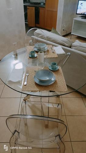 a glass table with a plate on top of it at Maison Mia in Parma